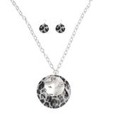 Long leopard pendant silver chain necklace set with matching fish hook earrings, featuring acrylic and metal discs.