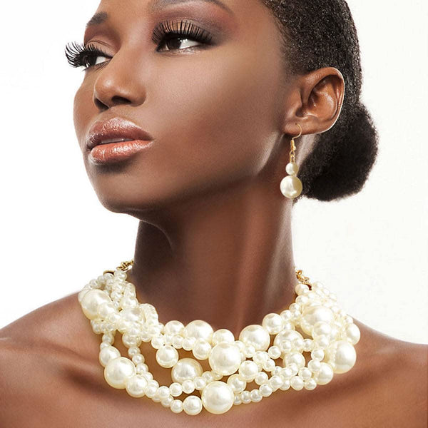 Elegant model showcasing a cream pearl twisted 5 strand necklace set, paired with matching earrings for a sophisticated look.