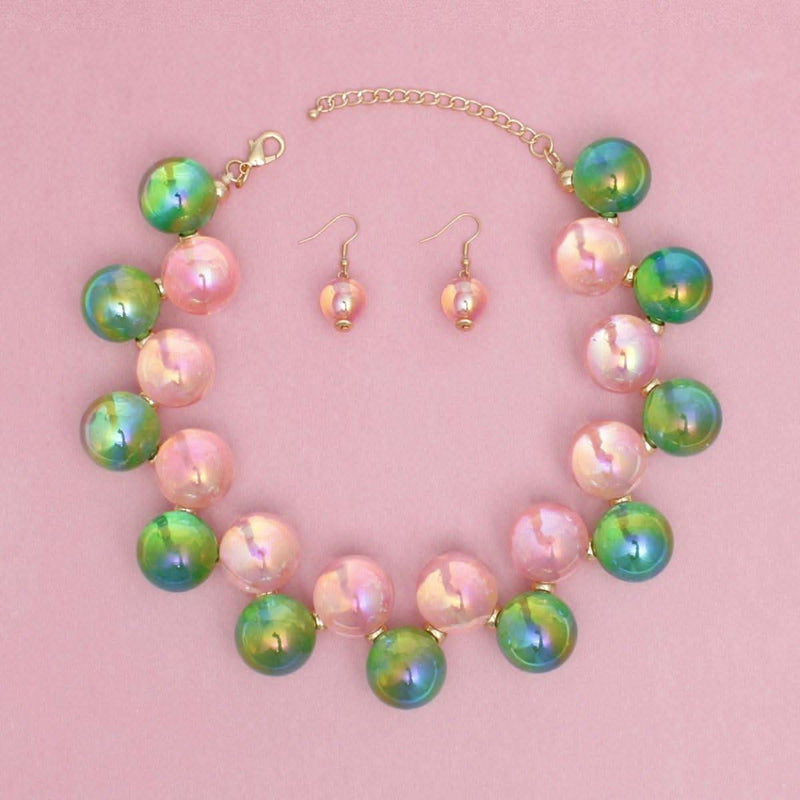 Women's pink and green iridescent bubble ball bead necklace set with matching earrings, featuring gold spacers.
